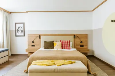 a bedroom with a large bed with colorful pillows at WorkNomads LAB Hotel in Sofia