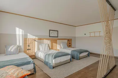 a bedroom with two beds and a hammock in it at WorkNomads LAB Hotel in Sofia