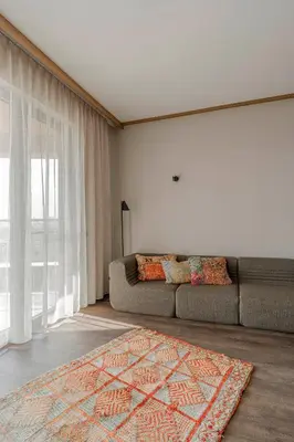 a living room with a couch and a rug at WorkNomads LAB Hotel in Sofia