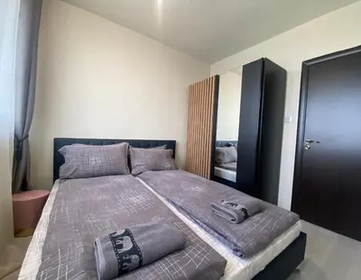 a bedroom with a large bed in a room at Brand new and modern apartment directly next to the metro station in Sofia