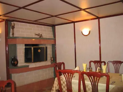 a dining room with a table and a fireplace at Darling Hotel in Sofia