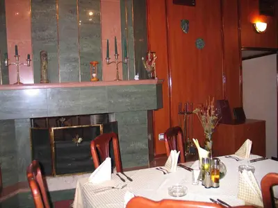 a dining room with a table and a fireplace at Darling Hotel in Sofia