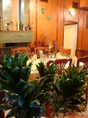 a dining room with a table and some plants at Darling Hotel in Sofia