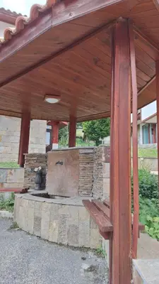 a wooden pavilion with a stone oven in a yard at Villa Carpe Diem in Pamporovo