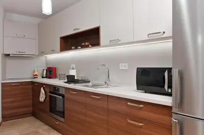 a kitchen with a sink and a microwave at Апартамент за гости Дарива in Smolyan