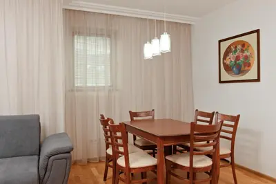 a dining room with a table and chairs at Апартамент за гости Дарива in Smolyan