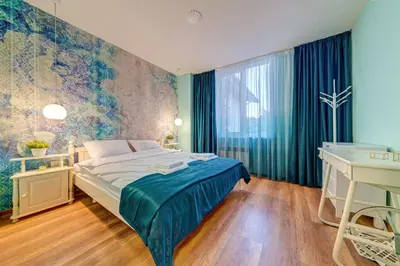 a bedroom with a bed and a desk and a window at ИНвела in Smolyan