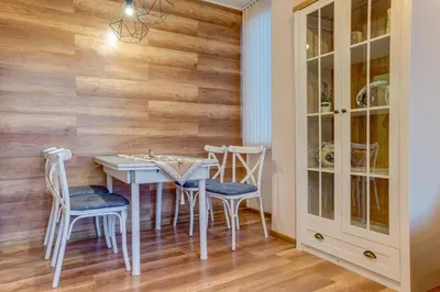 a dining room with a white table and chairs at ИНвела in Smolyan