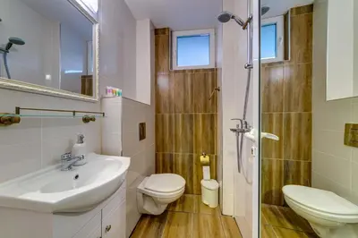 a bathroom with a sink and a toilet and a shower at ИНвела in Smolyan