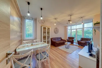 a kitchen and living room with a table and chairs at ИНвела in Smolyan