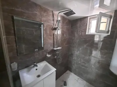 a bathroom with a sink and a shower at Апартаменти за гости ,,Тракия'' in Hisarya