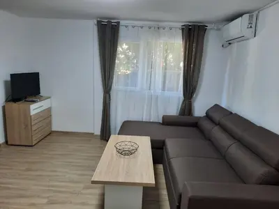a living room with a couch and a table at Апартаменти за гости ,,Тракия'' in Hisarya