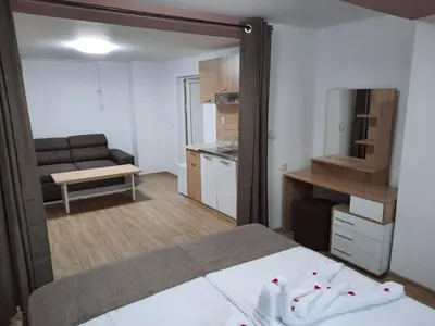 a small bedroom with a bed and a kitchen at Апартаменти за гости ,,Тракия'' in Hisarya