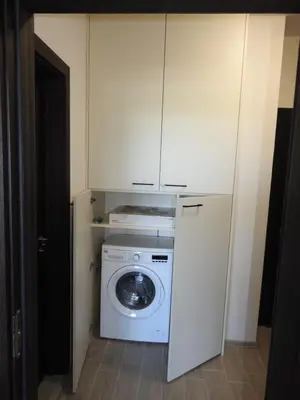 a washer and dryer in a small room at Vintage Studio Mladost in Sofia