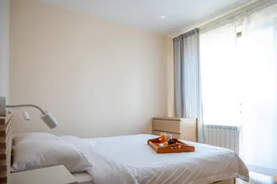 a bedroom with a bed with a tray on it at Modern and Spacious apartments in the City Centre in Sofia