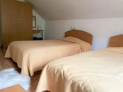 two beds in a room with two bedsskirts at Private Apartment Laplandia 77 (Pamporovo, Bulgaria) in Pamporovo