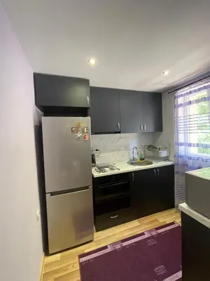 a kitchen with a stainless steel refrigerator and black cabinets at Св.Георги in Sapareva Banya