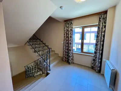 a staircase in a house with a window at Private Apartments next to Bellevue Residence in Bansko