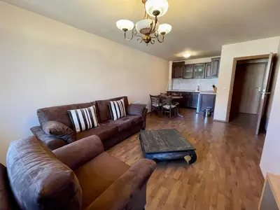 a living room with a couch and a table at Private Apartments next to Bellevue Residence in Bansko