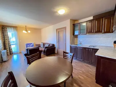 a kitchen and living room with a table and chairs at Private Apartments next to Bellevue Residence in Bansko