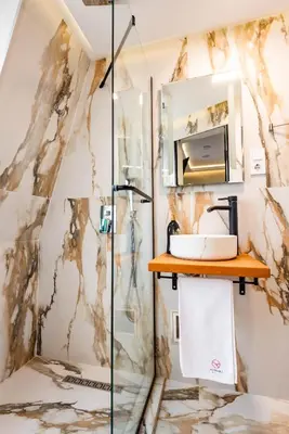 a bathroom with a shower and a sink at Aurora Hills Hotel in Plovdiv