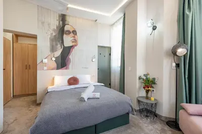 a bedroom with a large painting on the wall at Aurora Hills Hotel in Plovdiv