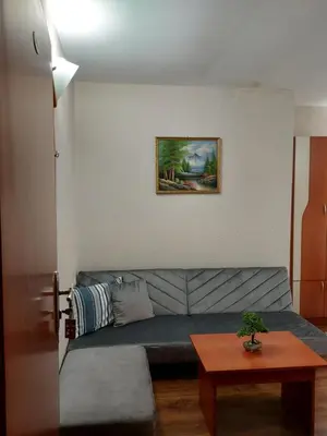 a living room with a couch and a table at Хотел Лагуна in Dospat