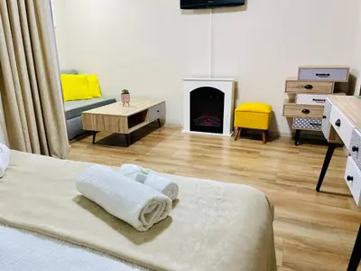 a bedroom with a bed and a fire place at Хотел Лагуна in Dospat