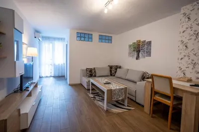a living room with a couch and a table at Karastoyanovi's apartment 2 in Sofia