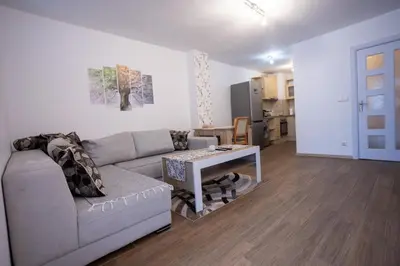 a living room with a couch and a table at Karastoyanovi's apartment 2 in Sofia