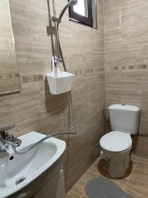 a bathroom with a toilet and a sink at Комплекс Омайник in Kalofer