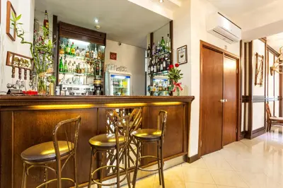 a bar with stools in a room at Family Hotel Teteven in Teteven