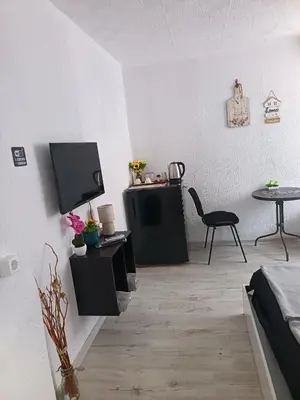 a room with a bed and a tv on a wall at The hiils 4 Plovdiv in Plovdiv