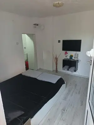 a bedroom with a bed and a flat screen tv at The hiils 4 Plovdiv in Plovdiv