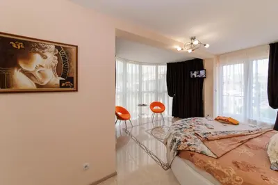 a bedroom with a bed and a painting on the wall at Sandanski Peak Guest Rooms in Sandanski
