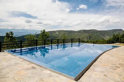 a swimming pool with a view of the mountains at Hotel Leshten in Leshten