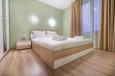 a bedroom with a large bed and a window at City Central 1-Bed Apartments in Plovdiv