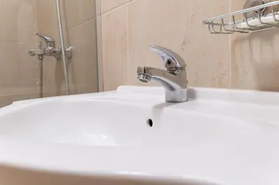 a bathroom sink with a faucet on top of it at City Central 1-Bed Apartments in Plovdiv