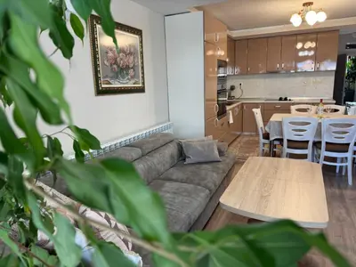 a living room with a couch and a table at Guest House Tatiana /Къща за гости ТАТЯНА in Petrich
