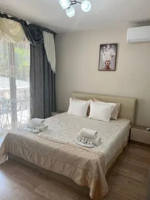 a bedroom with a bed with two towels on it at Guest House Tatiana /Къща за гости ТАТЯНА in Petrich