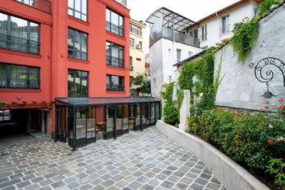 a brick walkway in front of a red building at Villa Flavia Heritage Boutique Hotel in Plovdiv
