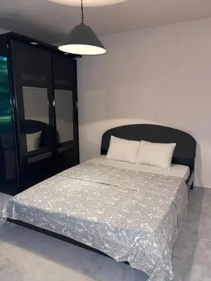 a bedroom with a bed with a black headboard and a mirror at Villa Alexa in Borovets