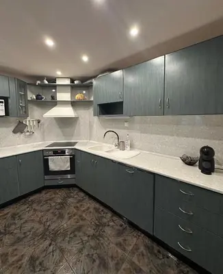 a kitchen with green cabinets and a sink and a stove at Villa Alexa in Borovets