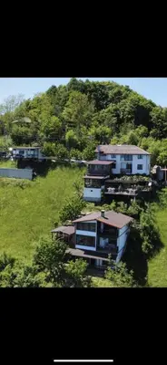 a group of buildings in a field with a hill at Александрова вила 2 in Zlatograd