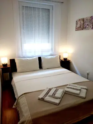 a bedroom with a bed with two towels on it at Karastoyanovi's apartment- Studentski grad in Sofia