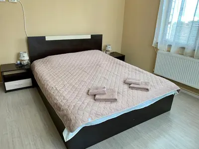 a bedroom with a bed with two towels on it at Sunny House in Madzhare