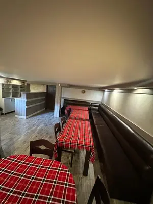 a dining room with two tables and a red table cloth at Advel Guest House in Madzhare