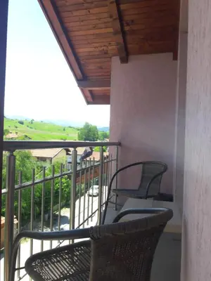 a balcony with chairs and a view of a field at Advel Guest House in Madzhare