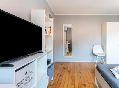 a living room with a flat screen tv on a white entertainment center at Lovely 1-bedroom apartment in the center of Sofia in Sofia