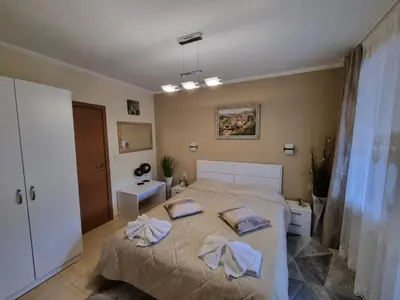 a bedroom with a bed with towels on it at Гранд Манастира Лукс in Pamporovo